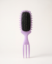 The Curl Trainer PRO curl defining brush in lavender, front view with clumping guide grooves and built-in volume pick