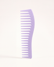 Essential Wide-Tooth Detangling Comb in lavender, standing upright to show its widely spaced teeth